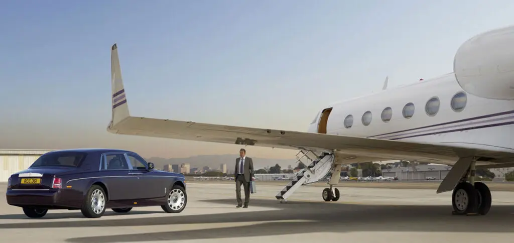 Rolls Royce near a Private jet at Boston Logan International Airport, Massachusetts