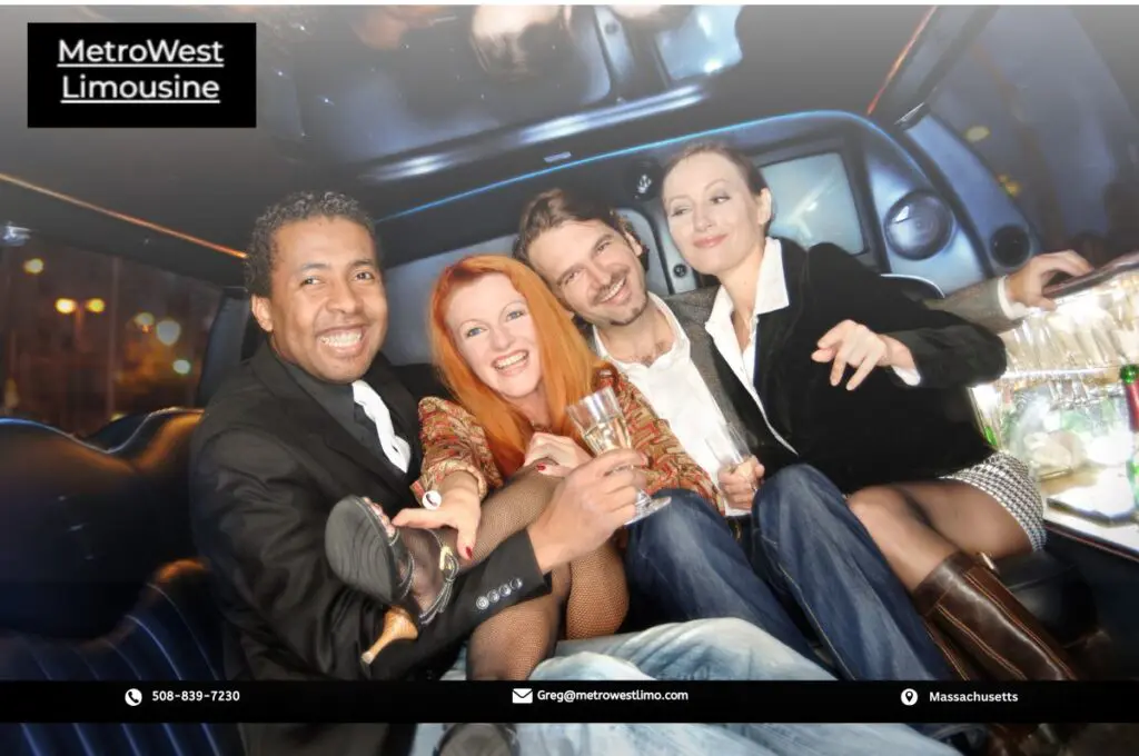 Group of friends toasting with drinks inside a limo service near Grafton, MA, celebrating a birthday