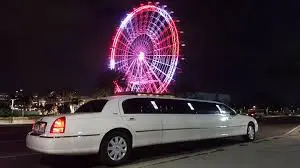 Stretch limousine white color parked outside a theme partk