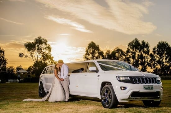 Luxury limo witha couple in front